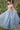 Ladivine light blue glitter tulle ballgown in motion, showing full sweeping skirt, sheer corset bodice, and pink floral embroidery