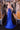 Ladivine royal blue sparkle evening gown back view, featuring a lace-up corset back detail, rhinestone embellishments, and a sweeping train.