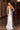 Ladivine silver sparkle evening gown back view, featuring a lace-up corset detail, rhinestone beading, and sweeping train.