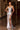 Ladivine silver sparkle evening gown with plunging V-neck illusion panel, full rhinestone beading, high leg slit, and spaghetti straps.