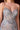 Extreme close-up of Ladivine gown bodice, showing intricate silver and iridescent rhinestone beading, blue and lavender floral embroidery, and sheer corset panel.