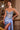 Close-up of Ladivine cielo blue satin gown, highlighting the sheer corset bodice, sweetheart neckline, beading, and high side slit with ruched detail.