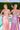 Ladivine dusty rose and lavender satin evening gowns, both featuring structured corset bodices with intricate beading and dramatic high side slits, posed by a swimming pool.