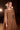 Close-up of a Ladivine bronze formal gown showcasing the intricate beaded bodice, boat neckline, and delicate split cape sleeves.