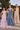 Ladivine Plunging Neckline A-line Tulle Gowns in Champagne, Smoky Blue, and Lavender, modeled by three wedding guests.
