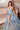 Ladivine Paris Blue Prom Dress: Plunging V-Neck A-Line Tulle Gown with High Slit, Model Seated
