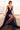 Ladivine Navy Wedding Guest Dress: Plunging V-Neck A-Line Tulle Gown with High Slit, Model Seated