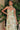 Close-up of Ladivine sage green floral print gown, showing draped sweetheart corset bodice and choker-style detachable scarf detail.