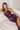 Close-up of Ladivine Eggplant Black Tie Dress, highlighting the Ruched Corset Bodice, Cowl Neckline, and fitted satin texture