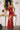 Ladivine Red Prom Dress: Fitted Satin Gown with Cowl Neckline, Corset Bodice, and high Thigh Slit, Model posing