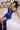 Ladivine Royal Blue Wedding Guest Gown with fitted Corset and Ruching, model seated