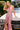 Close-up of the Ladivine pink iridescent sequin mermaid dress, emphasizing the deep plunge V-neckline, illusion mesh side cutouts, and high thigh slit.