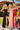 Three women in glamorous evening gowns standing outdoors on a checkered surface.