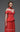 Close up of MNM Couture coral pleated corset off-shoulder evening gown