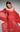MNM Couture coral off-shoulder evening gown with dramatic pleated bustier and flowing skirt