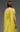 Back view of MNM Couture yellow evening gown E0119 showing pleated bodice and draped cape sleeves