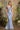 Andrea and Leo shimmering blue mermaid gown with a full baroque sequin and bead pattern, off-the-shoulder draped neckline, and a floral accent.