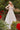 Model is posing near flowers in the Cinderella Divine CDS436W wedding dress