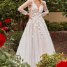 Model is posing near flowers in the Cinderella Divine CDS436W wedding dress
