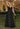 Ladivine T714 Black Satin A-Line Gown featuring a draped cowl neck and delicate spaghetti straps. Elegant long black formal dress.