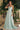 Ladivine T714 Soft Mint Satin A-Line Gown featuring a draped cowl neckline and thin spaghetti straps. Elegant, flowy, soft mint bridesmaid or prom dress
